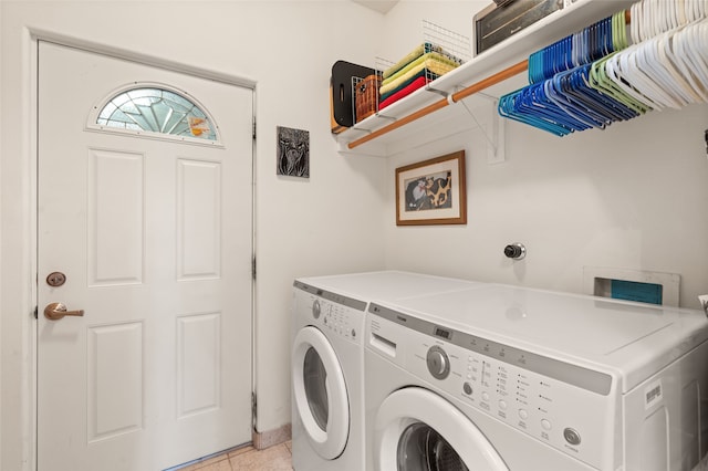 laundry area with washer and dryer, laundry area, and light tile patterned floors