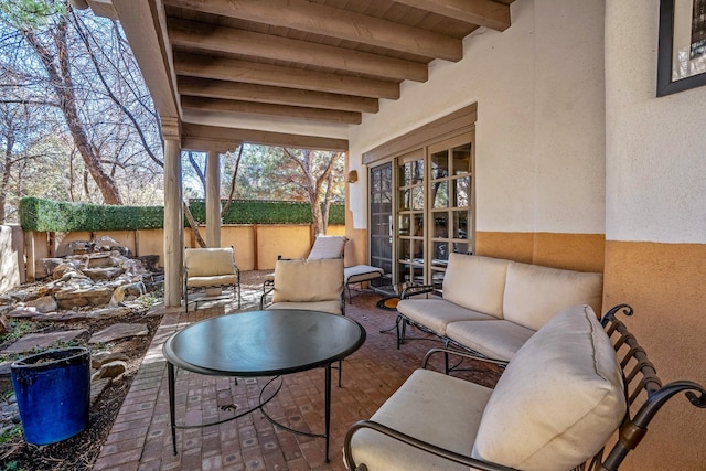 view of patio / terrace with an outdoor living space, french doors, and fence