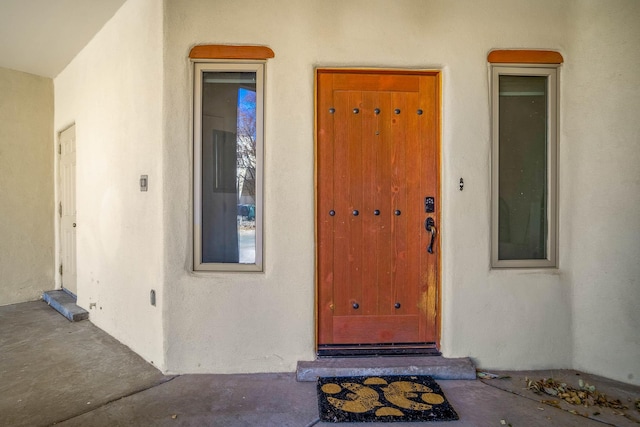 property entrance featuring stucco siding