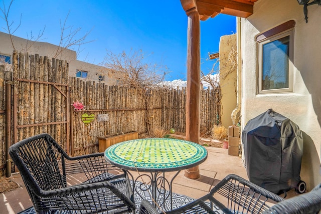 view of patio with grilling area and fence