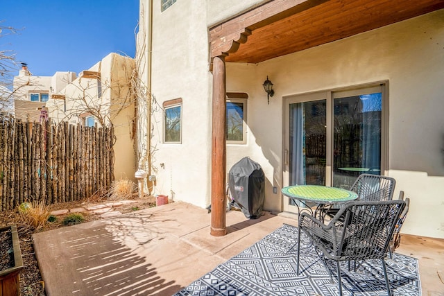 view of patio / terrace with area for grilling and fence