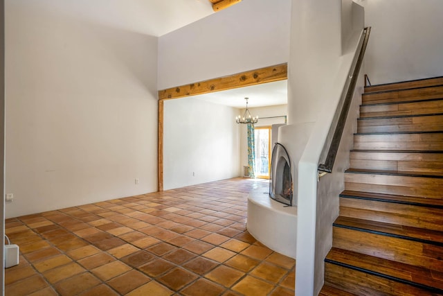 stairs with tile patterned flooring and a notable chandelier