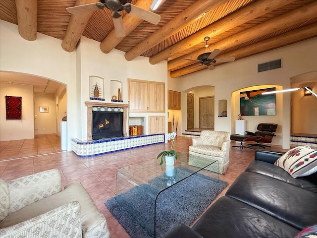 tiled living room featuring arched walkways, visible vents, wooden ceiling, and ceiling fan