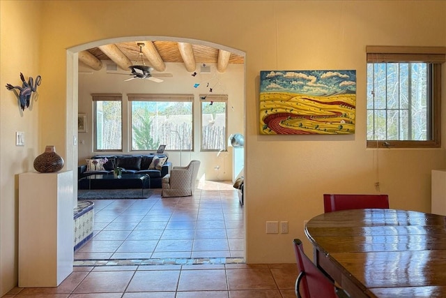 interior space with a wealth of natural light, beamed ceiling, tile patterned flooring, and wood ceiling