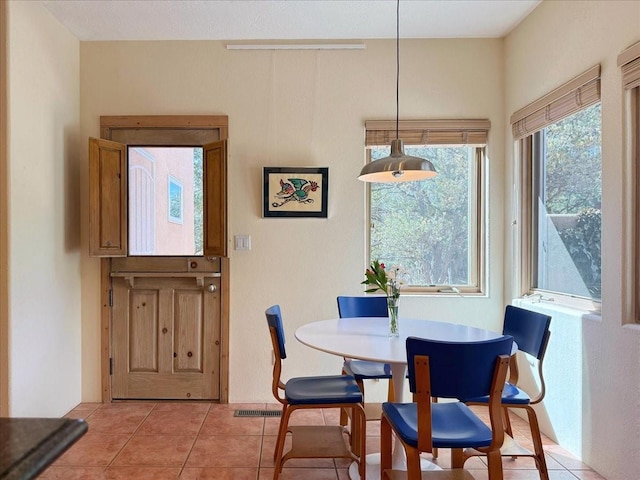 dining area featuring light tile patterned flooring