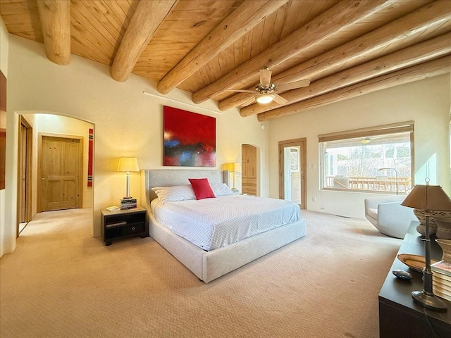 bedroom featuring ceiling fan, carpet floors, beam ceiling, wooden ceiling, and arched walkways