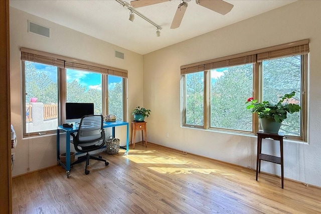 home office featuring visible vents, track lighting, ceiling fan, and wood finished floors