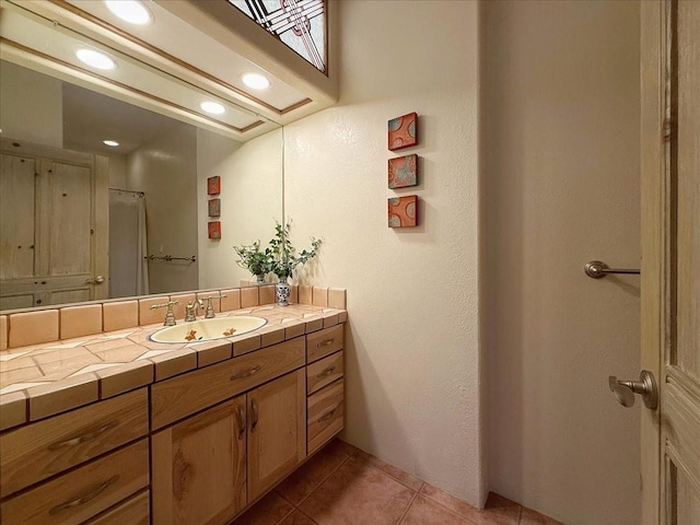 bathroom featuring recessed lighting, vanity, and tile patterned flooring