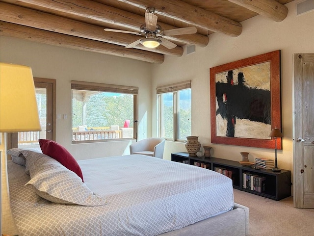 bedroom with visible vents, beamed ceiling, and carpet flooring