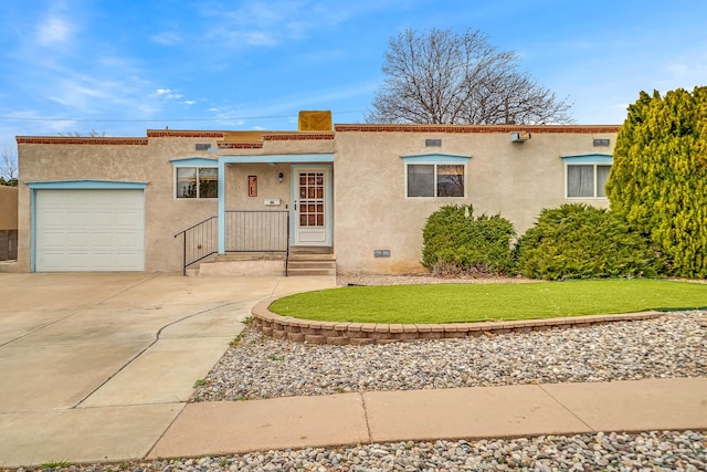 view of front of property featuring concrete driveway, an attached garage, and stucco siding