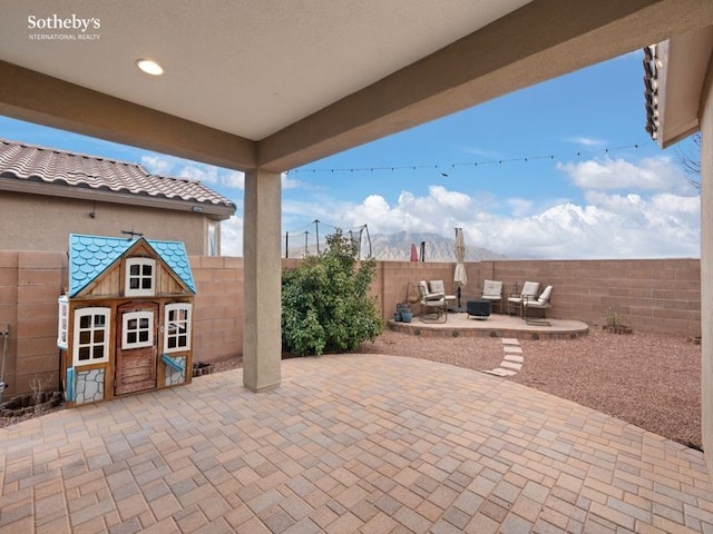 view of patio / terrace with an outbuilding and a fenced backyard