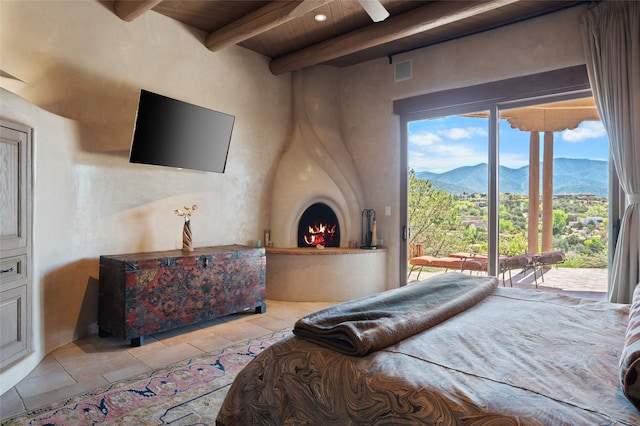 bedroom featuring access to exterior, beam ceiling, wooden ceiling, and light tile patterned flooring