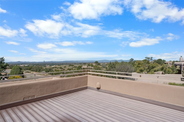 wooden deck with a mountain view and visible vents