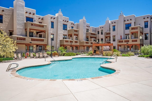 view of swimming pool with a patio area and fence