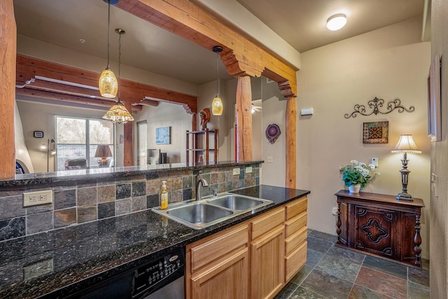 kitchen with decorative light fixtures, dishwasher, decorative backsplash, stone tile flooring, and a sink