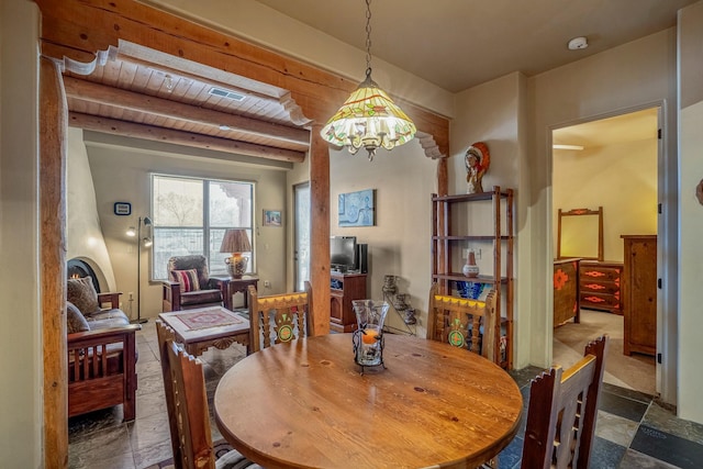 dining space with beam ceiling, visible vents, and wooden ceiling