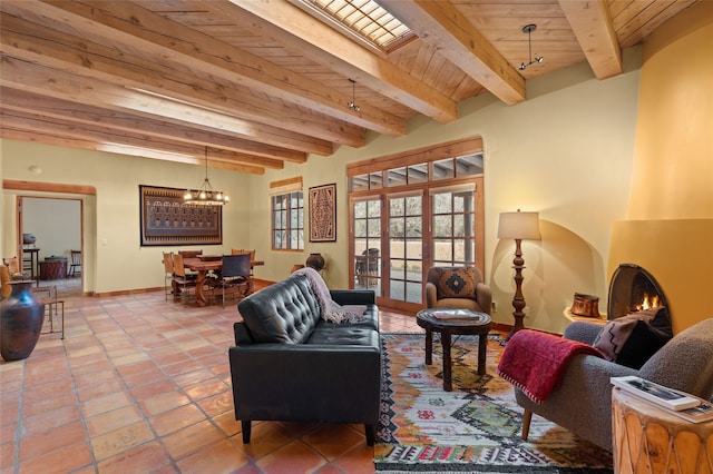 living area with beam ceiling, wood ceiling, french doors, tile patterned floors, and a large fireplace