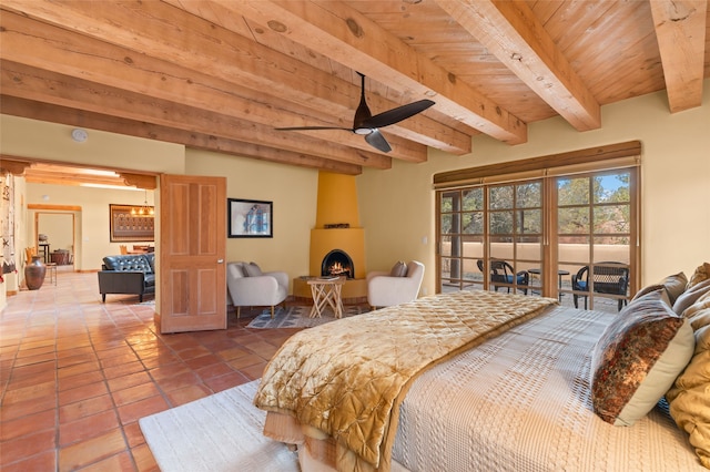 tiled bedroom with beamed ceiling, a large fireplace, access to exterior, and wooden ceiling