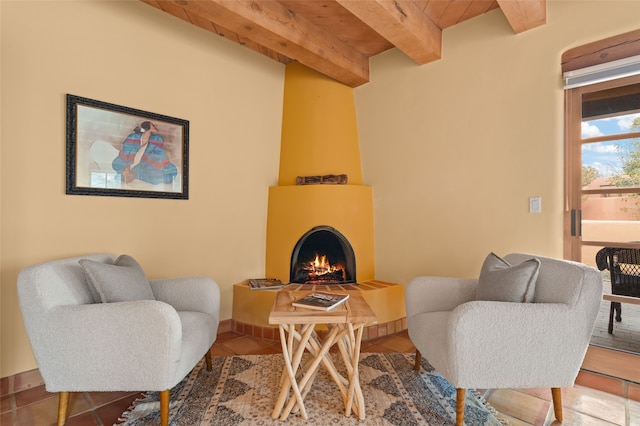 living area featuring beamed ceiling, wooden ceiling, a fireplace, and tile patterned flooring