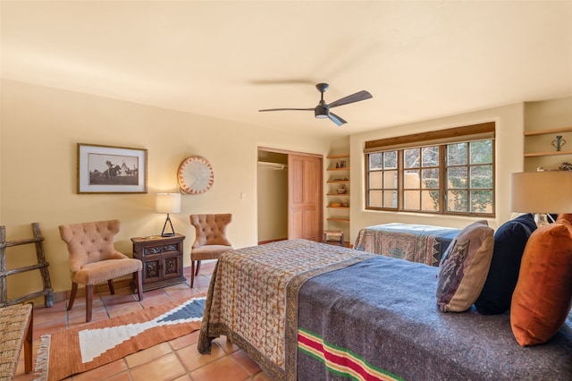 bedroom featuring light tile patterned floors, baseboards, a closet, and ceiling fan