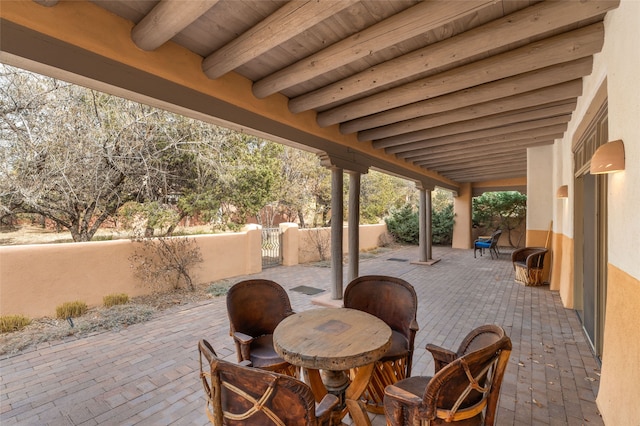 view of patio / terrace featuring outdoor dining space, fence, and a gate