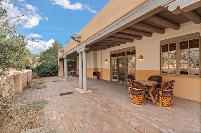 view of patio with outdoor dining space and fence