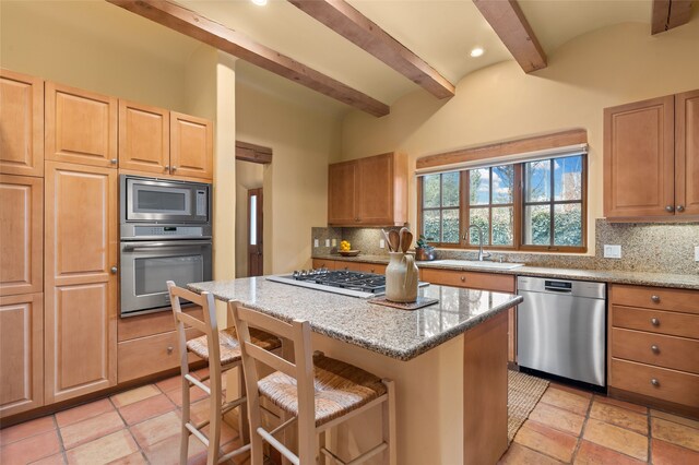 kitchen featuring beam ceiling, a sink, tasteful backsplash, a center island, and appliances with stainless steel finishes