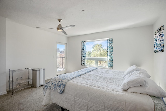 bedroom with access to exterior, baseboards, ceiling fan, and carpet floors