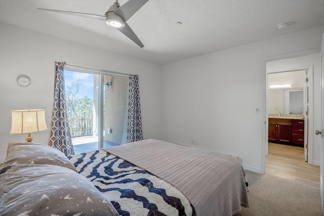 bedroom with a ceiling fan, a textured ceiling, baseboards, light colored carpet, and access to exterior