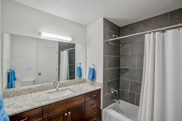 bathroom featuring vanity, toilet, shower / bath combo, and a textured ceiling