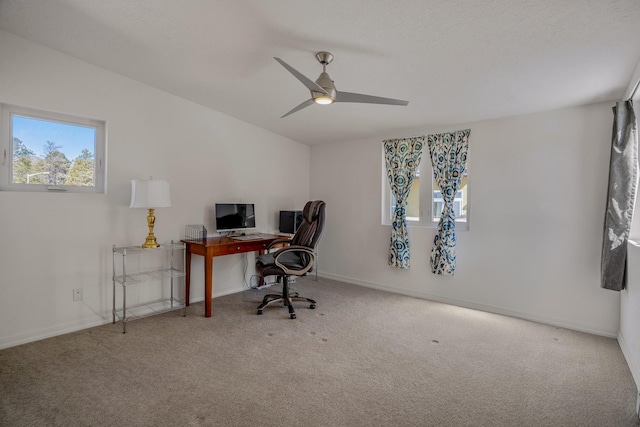 carpeted office featuring baseboards and ceiling fan