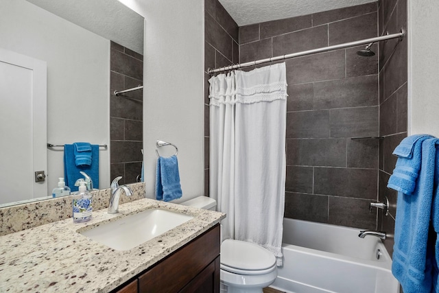 full bathroom with vanity, toilet, shower / tub combo, and a textured ceiling