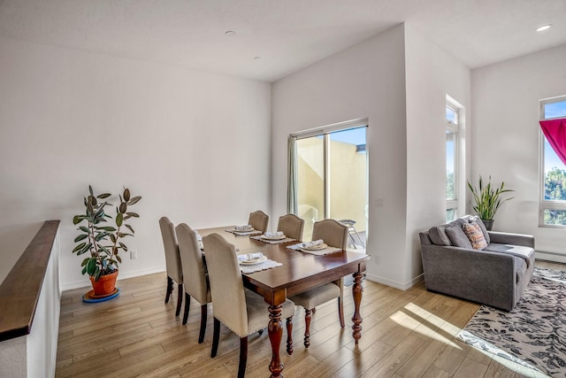 dining area with light wood finished floors, recessed lighting, and baseboards