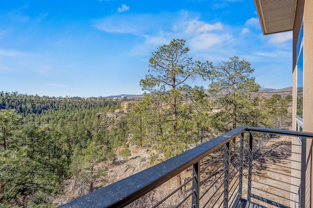 balcony with a view of trees and a mountain view