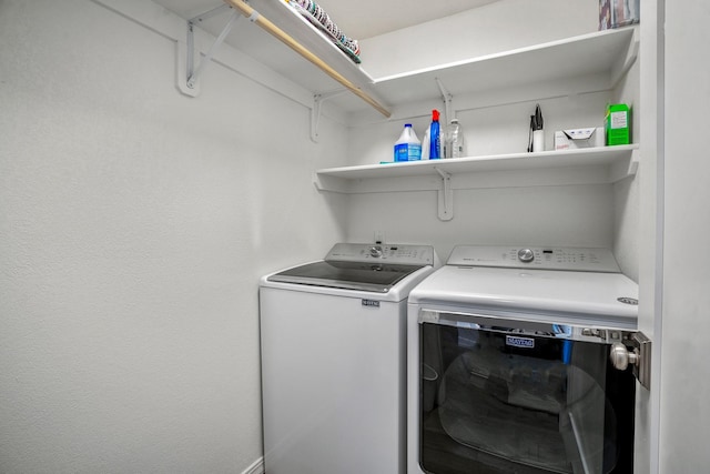 clothes washing area featuring washing machine and dryer and laundry area