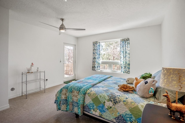 carpeted bedroom with access to outside, a ceiling fan, baseboards, and a textured ceiling