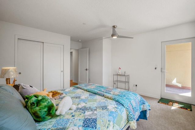 carpeted bedroom with a ceiling fan, baseboards, and a closet