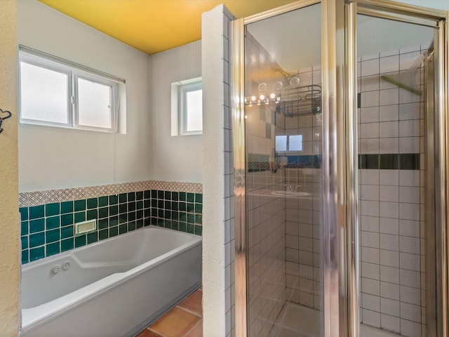 full bathroom with tile patterned floors, a garden tub, and a shower stall