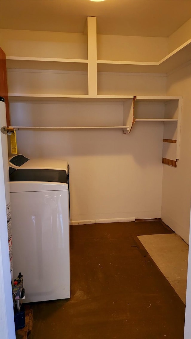 clothes washing area with washer / clothes dryer and water heater