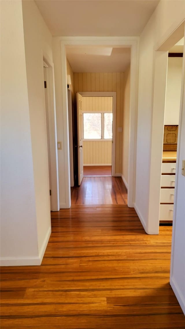 hallway with baseboards and light wood finished floors