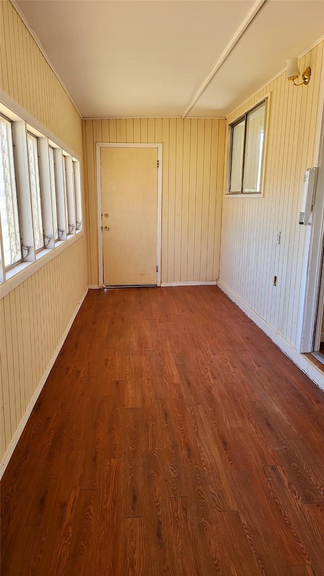 unfurnished room with baseboards and wood finished floors