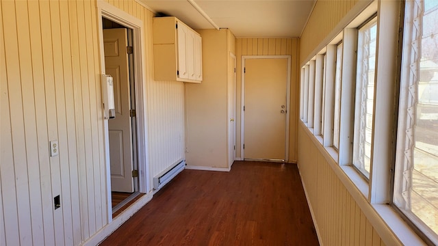 hall featuring plenty of natural light, baseboard heating, and dark wood-style flooring