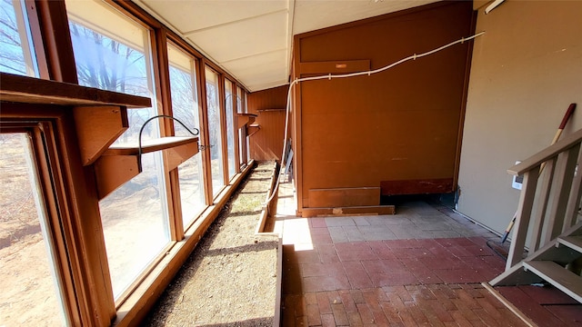 hall with brick floor and wooden walls