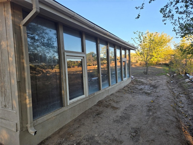 view of side of home featuring a sunroom