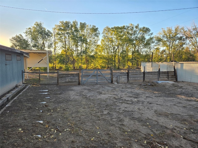 view of yard featuring fence and a gate