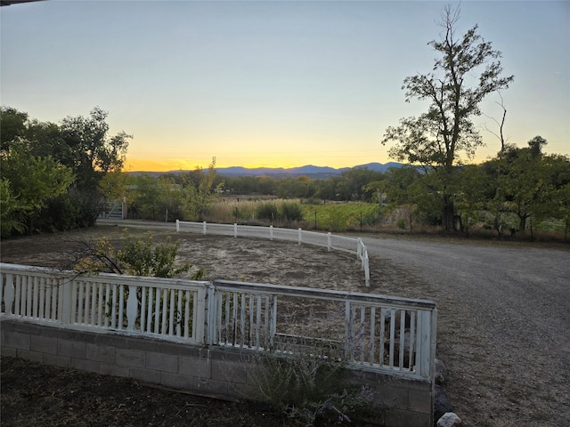 view of yard featuring fence and a mountain view