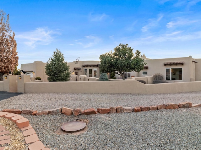 back of property featuring a fenced front yard