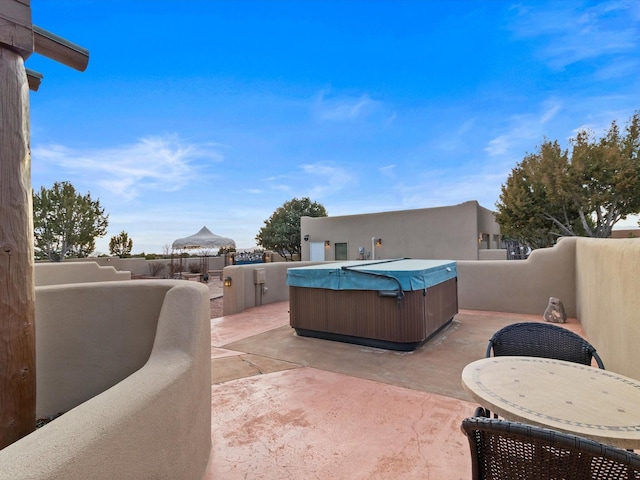 view of patio featuring a fenced backyard and a hot tub