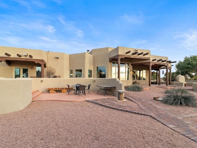 back of property featuring stucco siding and a patio area