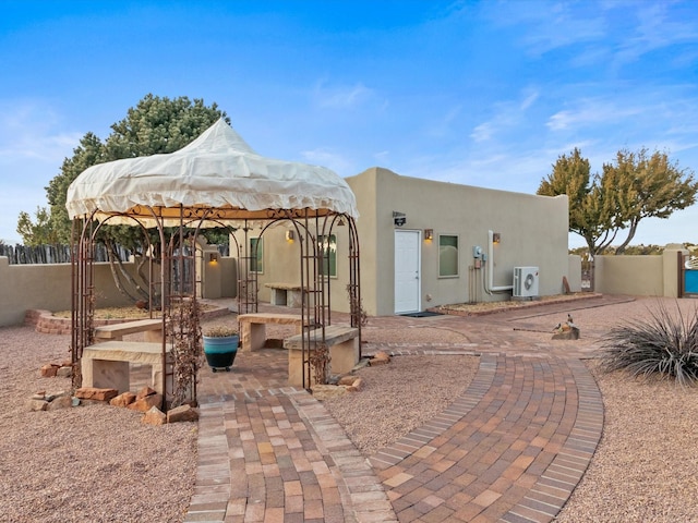 back of property featuring stucco siding, fence, a patio, and ac unit